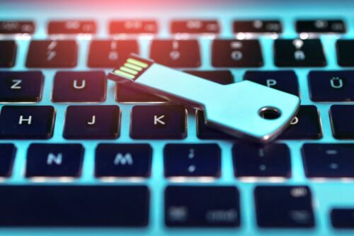 USB stick with child porno iamges is on the keyboard of the laptop. Visual concept for a criminal defense blog discussing possession of child pornography: penalties and defense.