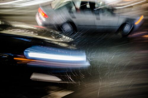 Blurry image of fast moving cars in a snowstorm. Visual concept for a blog discussing Hit and Run Defense.