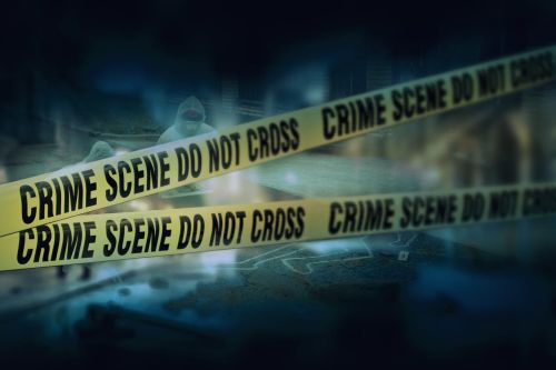 Police tape at crime scene sign do not cross. Visual concept for a legal blog discussing the difference between 1st and 2nd degrees of murder.