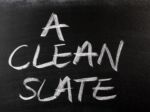 The phrase A Clean Slate handwritten on a used blackboard. Visual concept for a blog discussing Michigan's Clean Slate Law: Automatic Expungement.