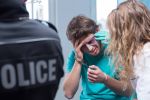 Policeman and man with handcuffs in hospital concept for Can The Police Access My Private Medical Or Hospital Records Following a DUI / OWI Arrest?
